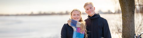 Roosa ja Karri Pesälä hymyilevät kameralle Hartaanselän rannalla.