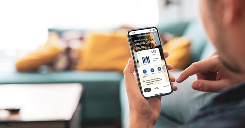Oulu Energia's mobile application open on the phone. the user is holding the phone.