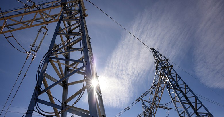 Two electricity towers with sky as a background.