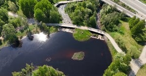 Aerial view from Hupisaaret in Oulu, showing water surface, road, and trees.